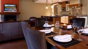 a dining room table and chairs in a room at Solara Resort by Bellstar Hotels in Canmore