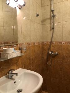 a bathroom with a sink and a shower at Hotel Silver in Sozopol