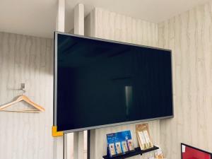 a flat screen tv hanging on a wall at Takahashi Building 3rd and 4th floors - Vacation STAY 21854v in Musashino