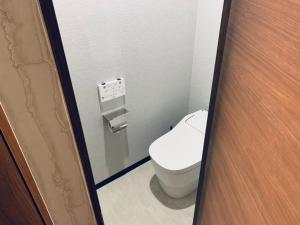 a bathroom with a toilet in a bathroom stall at Takahashi Building 3rd and 4th floors - Vacation STAY 24477v in Musashino
