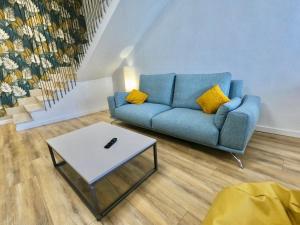 a living room with a blue couch and a coffee table at VUT REAL DE ARRIBA in El Barraco