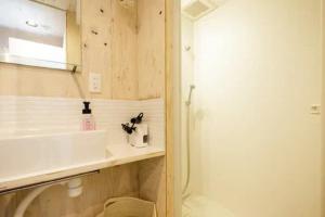 a bathroom with a sink and a toilet and a shower at Ōgi-en building 3 - Vacation STAY 12594 in Tokyo
