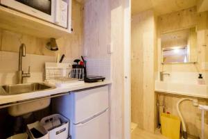 a small kitchen with a sink and a counter at Ōgi-en building 3 - Vacation STAY 12594 in Tokyo