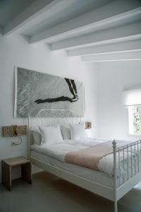 En eller flere senge i et værelse på Ecocirer Guest House