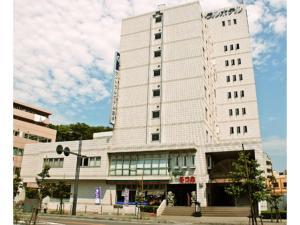 a white building with a lot of windows at Central Hotel Toride - Vacation STAY 09920v in Toride