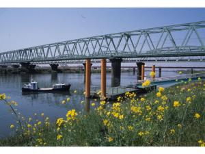 a bridge over a river with boats in the water at Central Hotel Toride - Vacation STAY 09920v in Toride