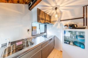 a kitchen with a sink and a refrigerator at Bettei Enoshima - Vacation STAY 20399v in Kamakura