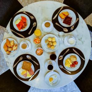 a white table with plates of food on it at Slaviero São Paulo Ibirapuera in São Paulo