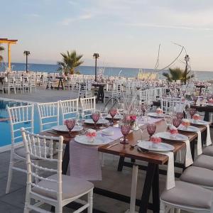 a table set up for a wedding on the beach at Ocean Hotel Resort in Kastrosikia