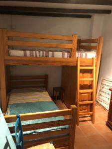 a bedroom with two bunk beds in a room at MAISON DE VILLAGE AUREL in Aurel