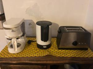 a coffee maker and a toaster on a counter at MAISON DE VILLAGE AUREL in Aurel