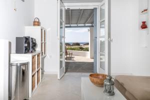 a kitchen and living room with a view of the ocean at Glyfada Veranda with Sea View in Naxos Chora
