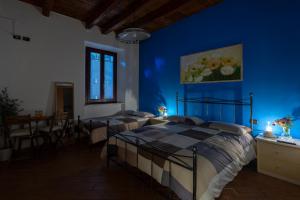 Affittacamere Carnevali MJ في لوريتو: غرفة نوم بسريرين وجدار ازرق