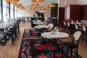 a row of tables and chairs in a restaurant at Best Western Porte du Forez in Andrézieux-Bouthéon