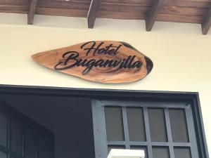 a sign on the side of a building at Hotel Buganvilla in Guaduas