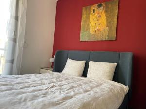 um quarto com uma cama com um quadro na parede em D-S Apartman Stella em Zamárdi