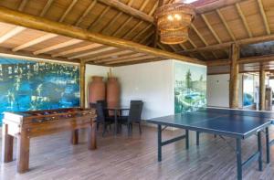 a ping pong table in a room with a ping pong ball at La Fleur Polinésia Muro Alto in Porto De Galinhas