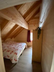 a bedroom with a bed in a wooden house at Haus Floriani, Appartement, Greifenburg, Karinthië in Greifenburg