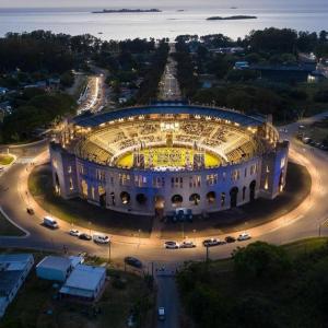 a large building with cars parked in a parking lot at jazmin1 in Colonia del Sacramento +4 photos