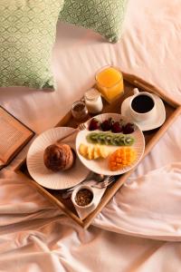 a tray with two plates of food on a bed at Casa Mayo B&B in Oaxaca City