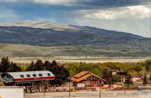 a train at a train station with mountains in the background at Blackstone Beauty condo in Park City