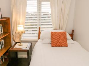 a small bedroom with a bed and a window at Victoria Cottage in Redcar