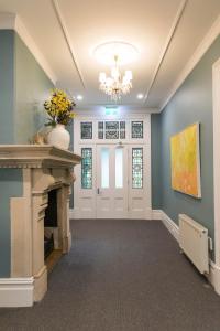 a living room with blue walls and a fireplace at Closeburn House in Mount Victoria