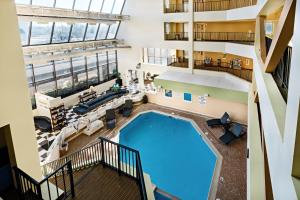 an overhead view of a pool in a building at The Atrium Resort by VSA Resorts in Virginia Beach