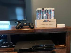 a wooden table with a television and dvds at **Stylish Pet Friendly 3 Bedroom House** in Cleveland