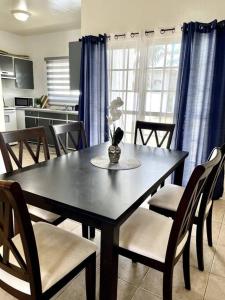 a dining room table and chairs in a kitchen at beautiful 4 bedroom tumon house in Tamuning