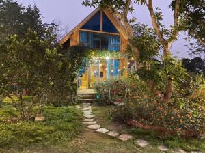 a wooden house with a pathway leading up to it at Sunny Home Ba Vì - Venue Travel in Hanoi