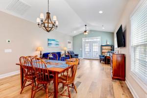 a dining room and living room with a table and chairs at 24th Ave Retreat in Myrtle Beach