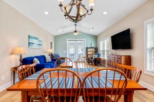 a dining room and living room with a table and chairs at 24th Ave Retreat in Myrtle Beach