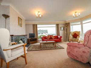 a living room filled with furniture and a fireplace at Gwel An Mor in Newquay