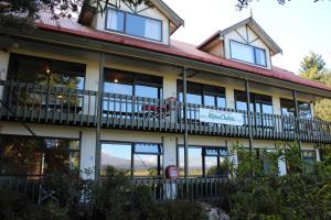 a large building with windows and a balcony at Alpine Chalets in National Park