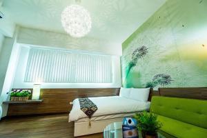 a bedroom with a bed and a chandelier at Yizhong Street Hechen in Taichung