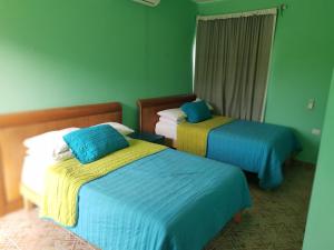 Ένα ή περισσότερα κρεβάτια σε δωμάτιο στο Villa Oasis Cancun Airport