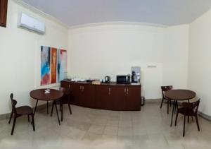 a room with two tables and chairs and a counter at Jatra Flagship Rajshahi City Centre in Rājshāhi