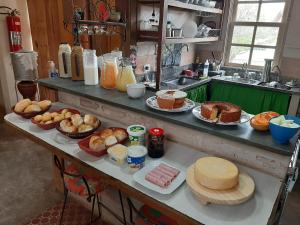 a table with many different types of food on it at Pousada Mundo Consciente in Piumhi