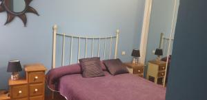 a bedroom with a bed with two pillows on it at Apartamentos Atlanterra COSTA Y SOL in Zahara de los Atunes