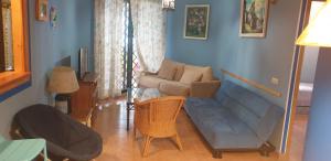 a living room with a couch and a chair at Apartamentos Atlanterra COSTA Y SOL in Zahara de los Atunes