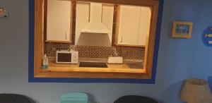 a kitchen with a counter with two microwaves at Apartamentos Atlanterra COSTA Y SOL in Zahara de los Atunes