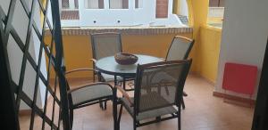 a table and chairs with a bowl on top of it at Apartamentos Atlanterra COSTA Y SOL in Zahara de los Atunes