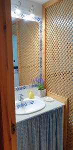 a bathroom with a sink and a mirror at Apartamentos Atlanterra COSTA Y SOL in Zahara de los Atunes