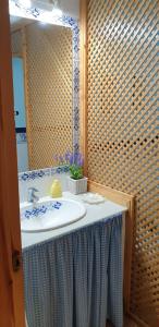 a bathroom with a sink and a mirror at Apartamentos Atlanterra COSTA Y SOL in Zahara de los Atunes
