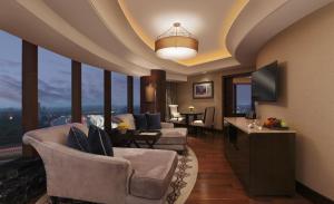 a living room with a couch and chairs and a television at The Leela Ambience Gurugram Hotel & Residences - The Luxury Urban Sanctuary in Gurgaon +37 photos