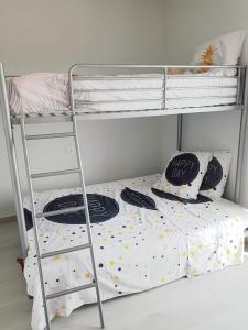 a bedroom with a bunk bed and a ladder at Le petit nid de Xanie in Orihuela