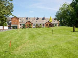 a putting green in front of a building at Tilly Mint Cottage in Penrith