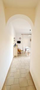 a living room with a tile floor and a table at Casa Maris in Alcamo