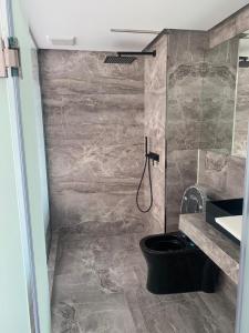 a bathroom with a toilet and a sink at Nirundorn Resort Chaam in Cha Am